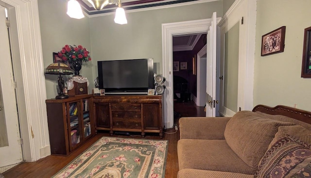 living room featuring ornamental molding and wood finished floors