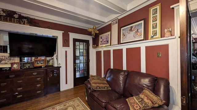 living room with beam ceiling, ornamental molding, and dark wood-type flooring