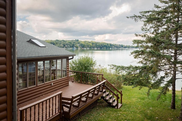 deck with a lawn and a water view