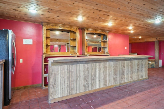 bar featuring stainless steel fridge, wood ceiling, and tile patterned flooring