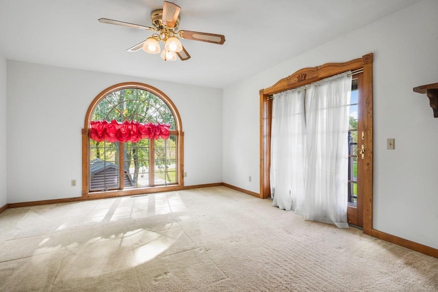 carpeted empty room featuring ceiling fan