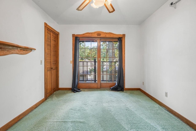 empty room with ceiling fan and carpet flooring