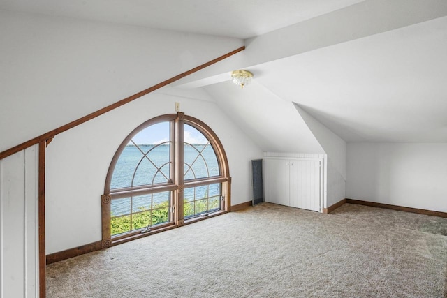 bonus room with vaulted ceiling and carpet floors