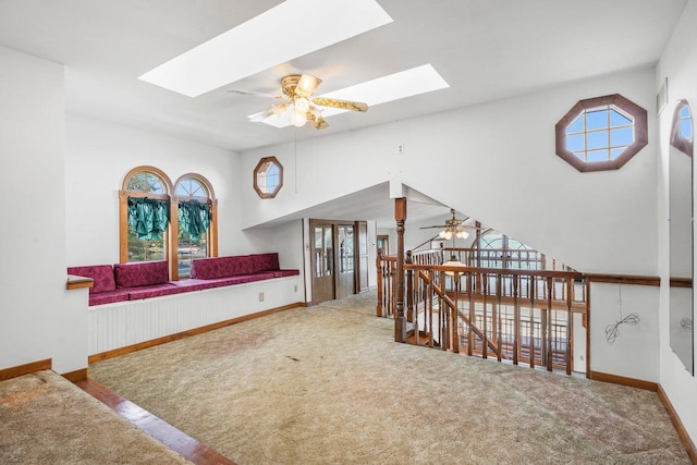 interior space with carpet floors, a skylight, and plenty of natural light