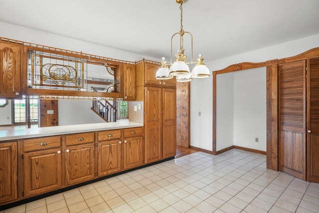 kitchen featuring decorative light fixtures, a chandelier, and light tile patterned floors