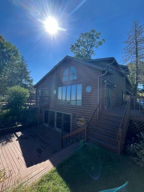 rear view of house with a wooden deck