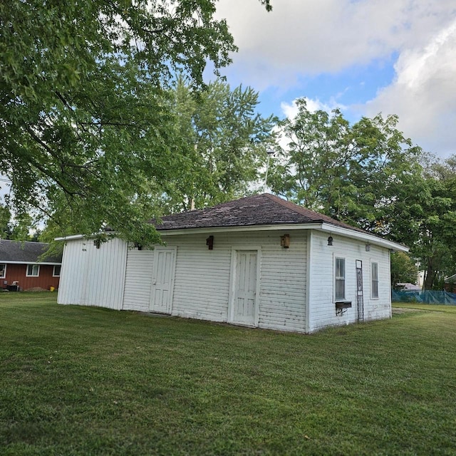 view of outbuilding featuring a lawn