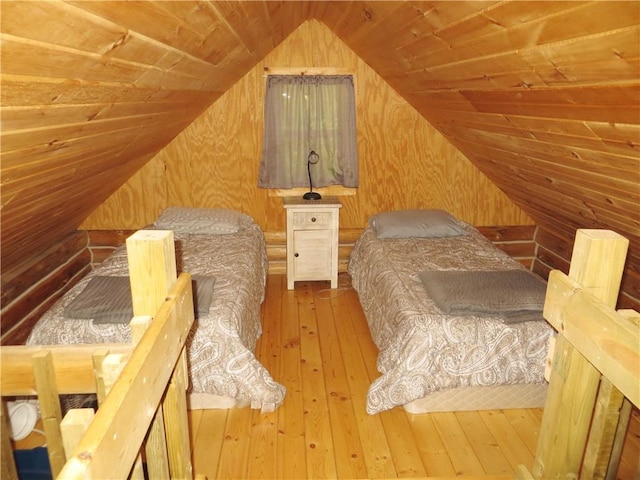 bedroom featuring wooden ceiling, wood walls, vaulted ceiling, and hardwood / wood-style flooring