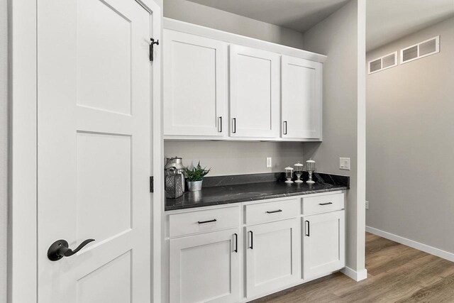 2876 Wild Goose Way, Stoughton, WI 53589 - bar featuring baseboards, light wood-type flooring, and visible vents