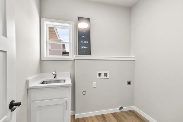 2876 Wild Goose Way, Stoughton, WI 53589 - washroom with light wood-style flooring, hookup for a washing machine, baseboards, a sink, and hookup for an electric dryer