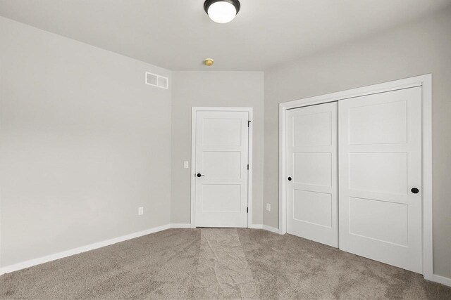 2876 Wild Goose Way, Stoughton, WI 53589 - unfurnished bedroom featuring baseboards, visible vents, a closet, and carpet