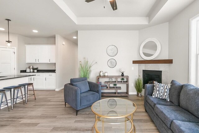 2876 Wild Goose Way, Stoughton, WI 53589 - living area featuring a tile fireplace, baseboards, ceiling fan, recessed lighting, and light wood-style floors