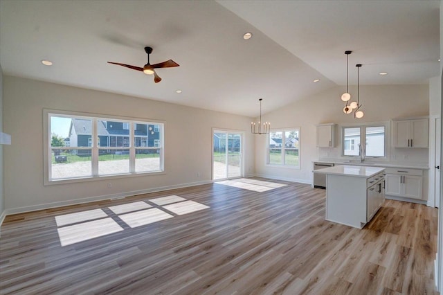 kitchen featuring light wood-type flooring, plenty of natural light, white cabinetry, and a center island