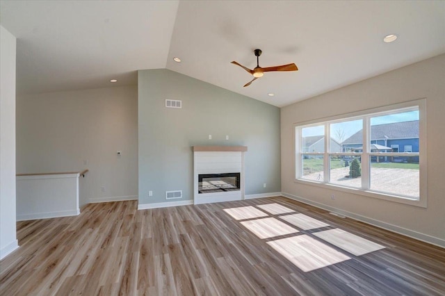 unfurnished living room with ceiling fan, light hardwood / wood-style floors, and vaulted ceiling