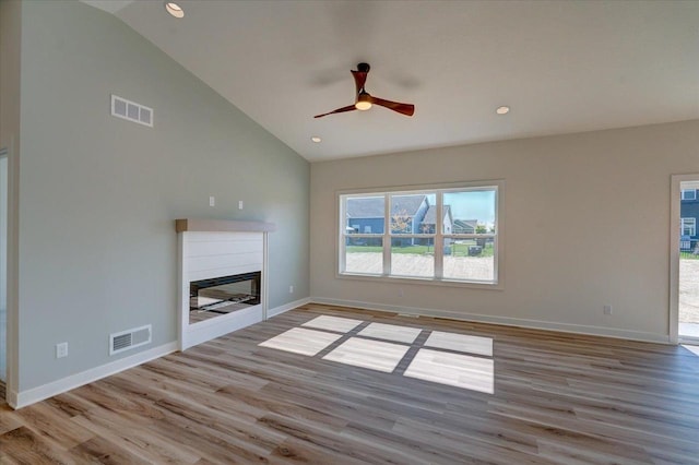 unfurnished living room featuring high vaulted ceiling, ceiling fan, and light hardwood / wood-style floors