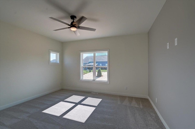 carpeted spare room featuring ceiling fan