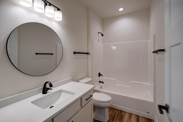 full bathroom featuring tub / shower combination, hardwood / wood-style floors, vanity, and toilet