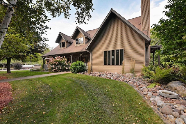 view of side of property with a yard