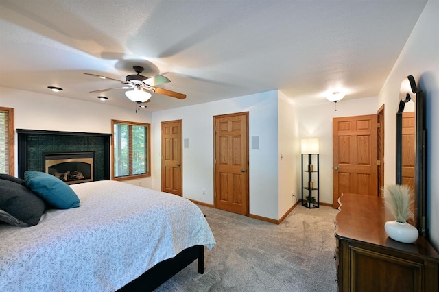 carpeted bedroom with ceiling fan and a textured ceiling