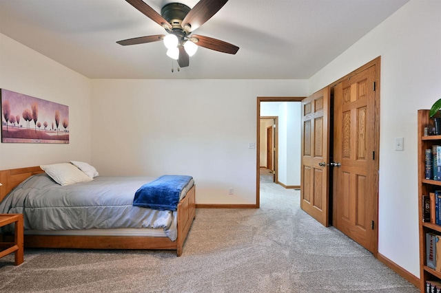 bedroom featuring a closet, ceiling fan, and light colored carpet