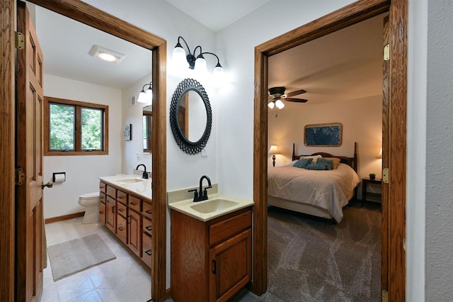 bathroom with ceiling fan, vanity, and toilet