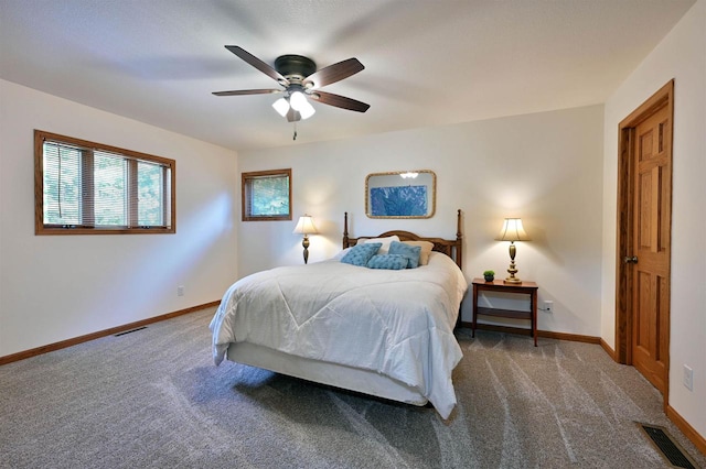 bedroom featuring ceiling fan and dark colored carpet