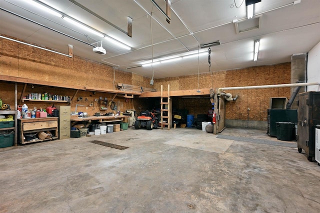 garage with a garage door opener and a workshop area