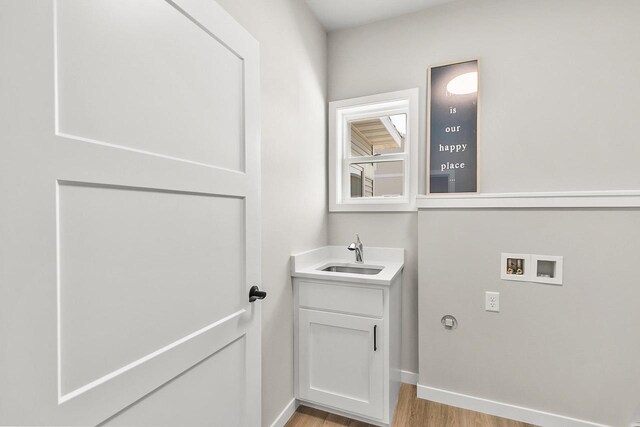 bathroom with vanity, baseboards, and wood finished floors