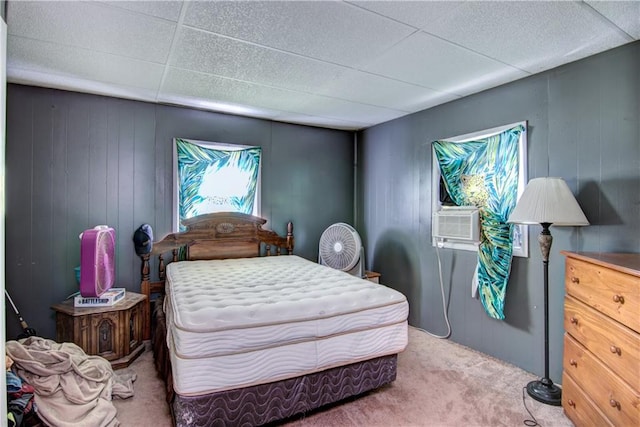 bedroom with carpet floors, cooling unit, and a paneled ceiling