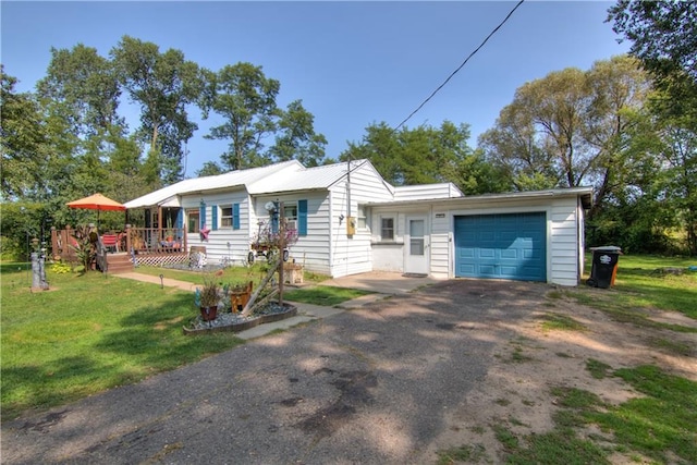 single story home with a garage and a front yard