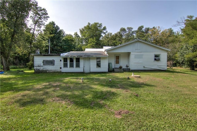 back of house featuring a yard