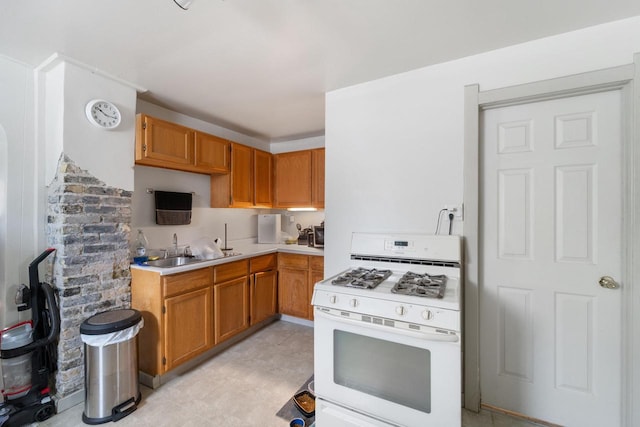 kitchen with sink and gas range gas stove