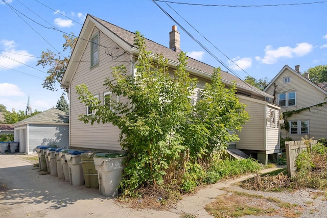 view of side of property featuring an outbuilding and a garage