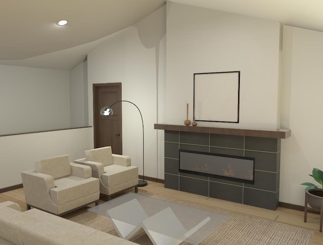 living room featuring a tiled fireplace, light hardwood / wood-style floors, and lofted ceiling