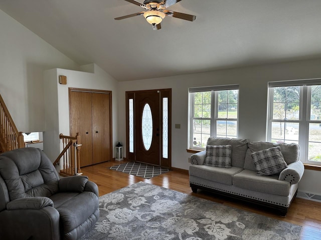 living room with light wood-type flooring, ceiling fan, and plenty of natural light