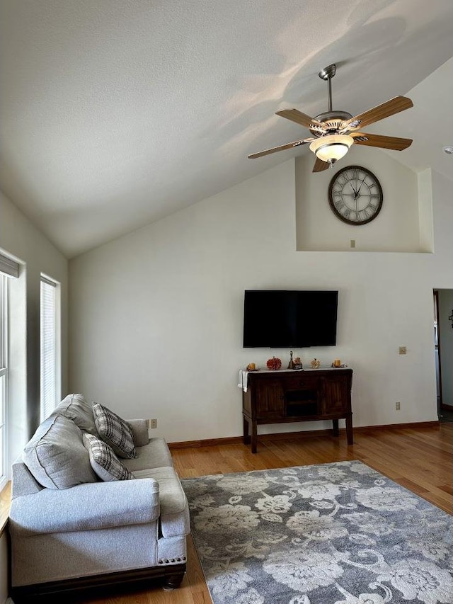 living room featuring a textured ceiling, lofted ceiling, hardwood / wood-style floors, and ceiling fan