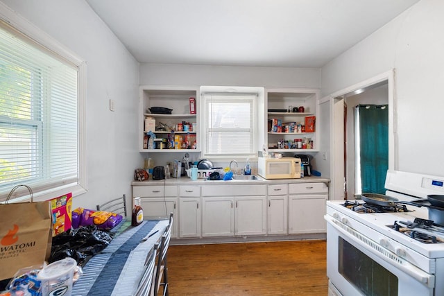 kitchen with white cabinets, sink, dark hardwood / wood-style flooring, and white appliances