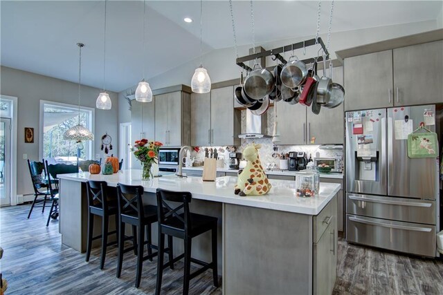 6030 Mitchell Rd, Iron River, WI 54847 - kitchen with decorative backsplash, light countertops, stainless steel appliances, dark wood-type flooring, and lofted ceiling