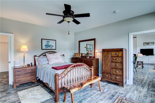 bedroom with ceiling fan and hardwood / wood-style flooring