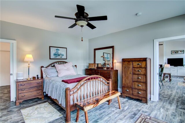 6030 Mitchell Rd, Iron River, WI 54847 - bedroom featuring a ceiling fan and wood finished floors