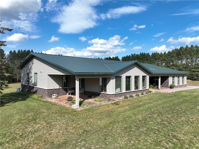 6030 Mitchell Rd, Iron River, WI 54847 - view of front of house featuring stone siding, a front lawn, and metal roof