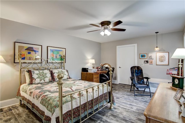 bedroom with ceiling fan and dark hardwood / wood-style flooring