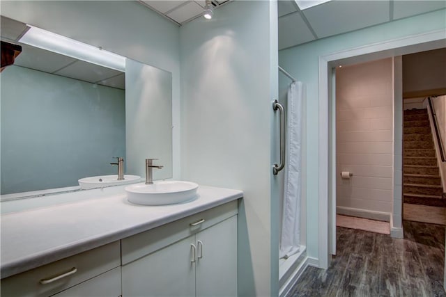 bathroom featuring a paneled ceiling, vanity, a shower with shower curtain, and hardwood / wood-style flooring