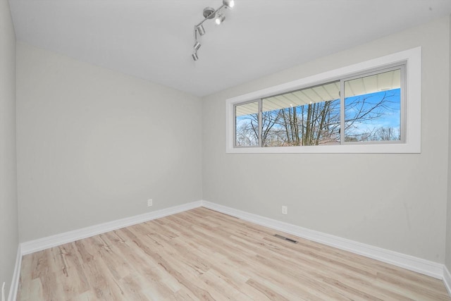 spare room with light hardwood / wood-style floors