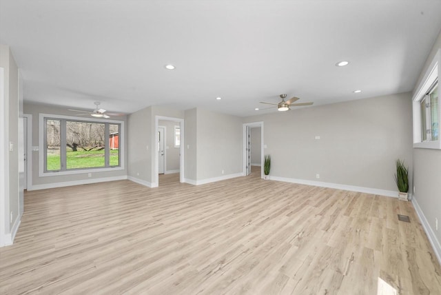 unfurnished living room featuring ceiling fan and light wood-type flooring