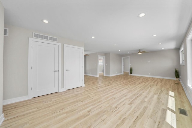 unfurnished living room with light wood-type flooring and ceiling fan