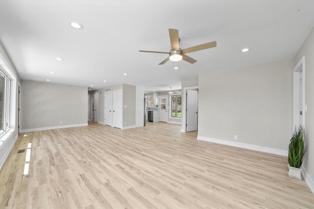 unfurnished living room featuring light wood-type flooring and ceiling fan