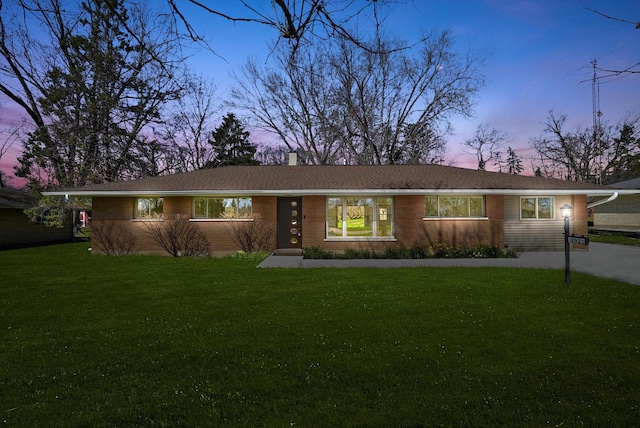 ranch-style home featuring a yard