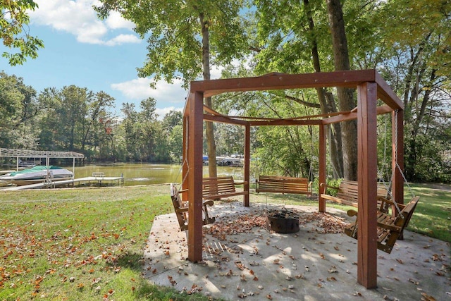 view of yard with a patio area, a water view, and a boat dock