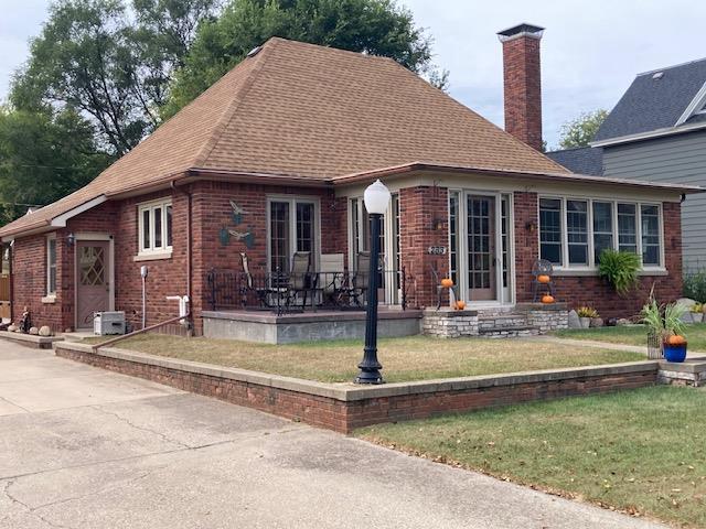 view of front of property with a front yard and french doors